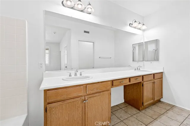 a bathroom with a sink vanity and mirror