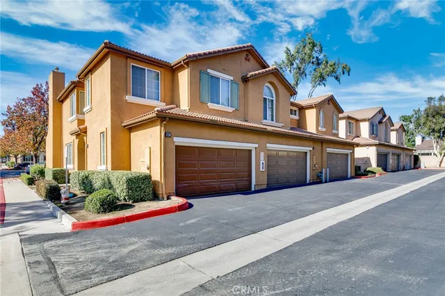 a front view of a house with plants