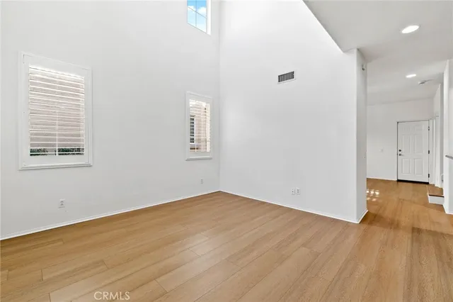 a view of a room with wooden floor and a window