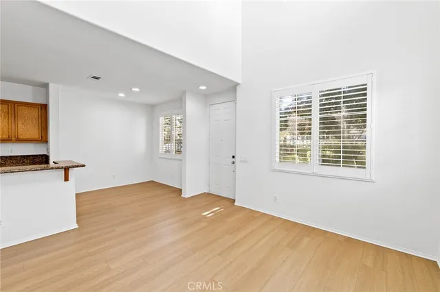 a view of a livingroom with a kitchen and a window