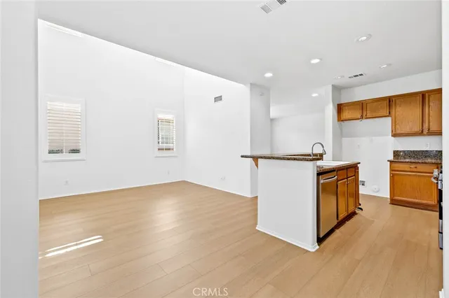 a view of kitchen with wooden floor and electronic appliances