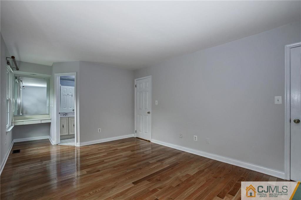 1902 Timber Oaks Road Edison, NJ 08820 - Photo 16 of 22 a view of an empty room with wooden floor