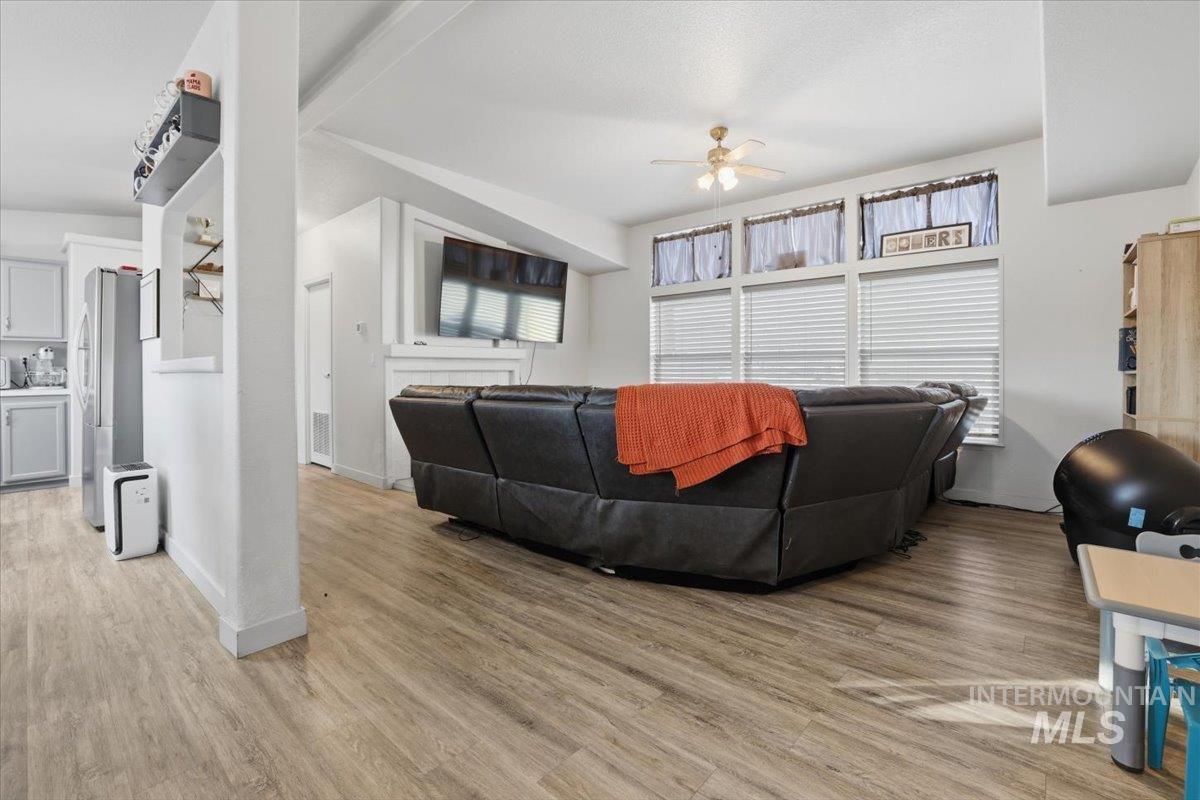 545 South Conover Street Eagle, ID 83616 - Photo 12 of 39 Living room with a ceiling fan, light wood-style floors, and plenty of natural light