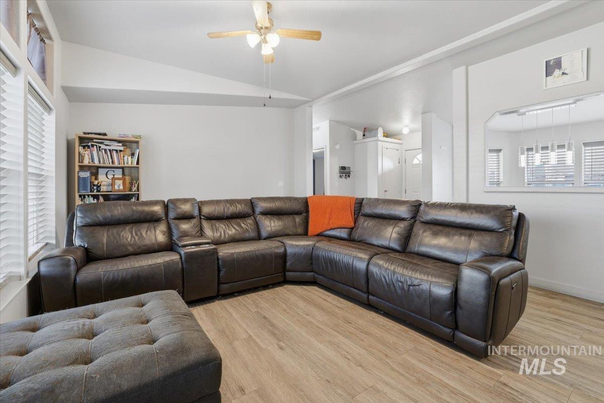 545 South Conover Street Eagle, ID 83616 - Photo 14 of 39 Living room with healthy amount of natural light, lofted ceiling, light wood-style flooring, and ceiling fan