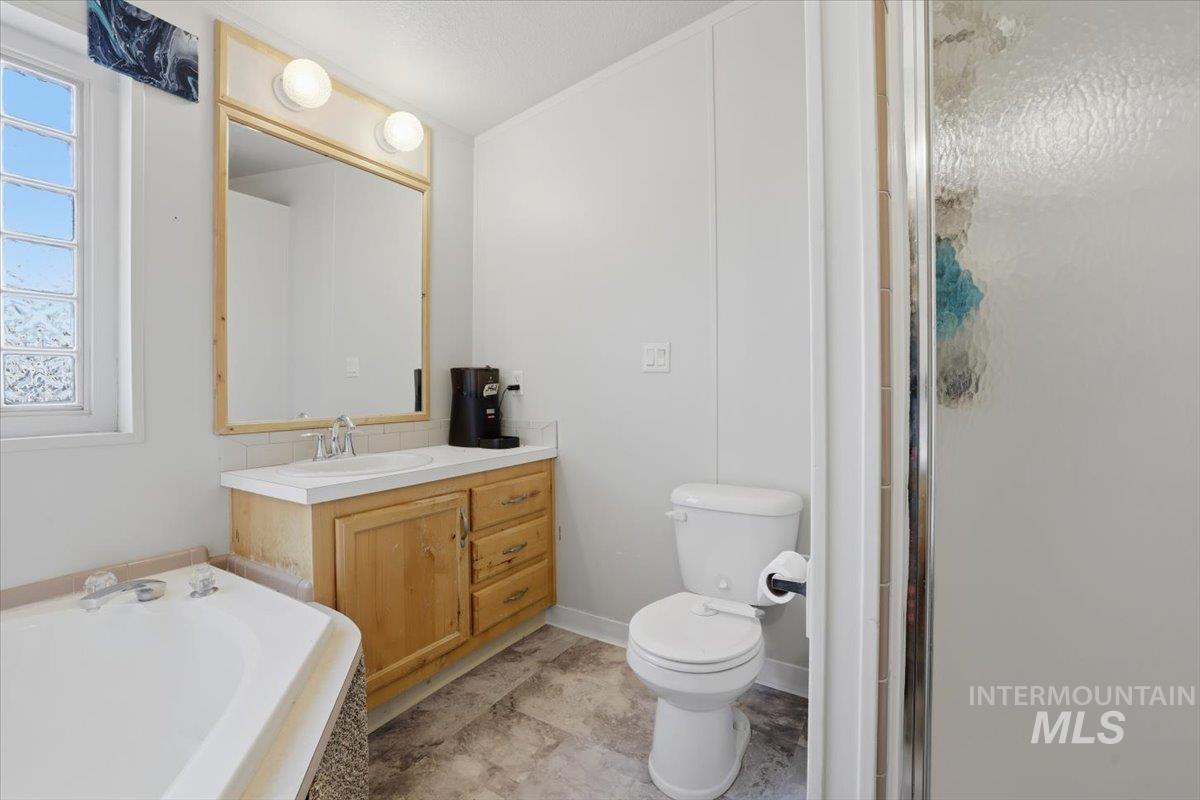 545 South Conover Street Eagle, ID 83616 - Photo 20 of 39 Bathroom with vanity, a garden tub, and a shower stall