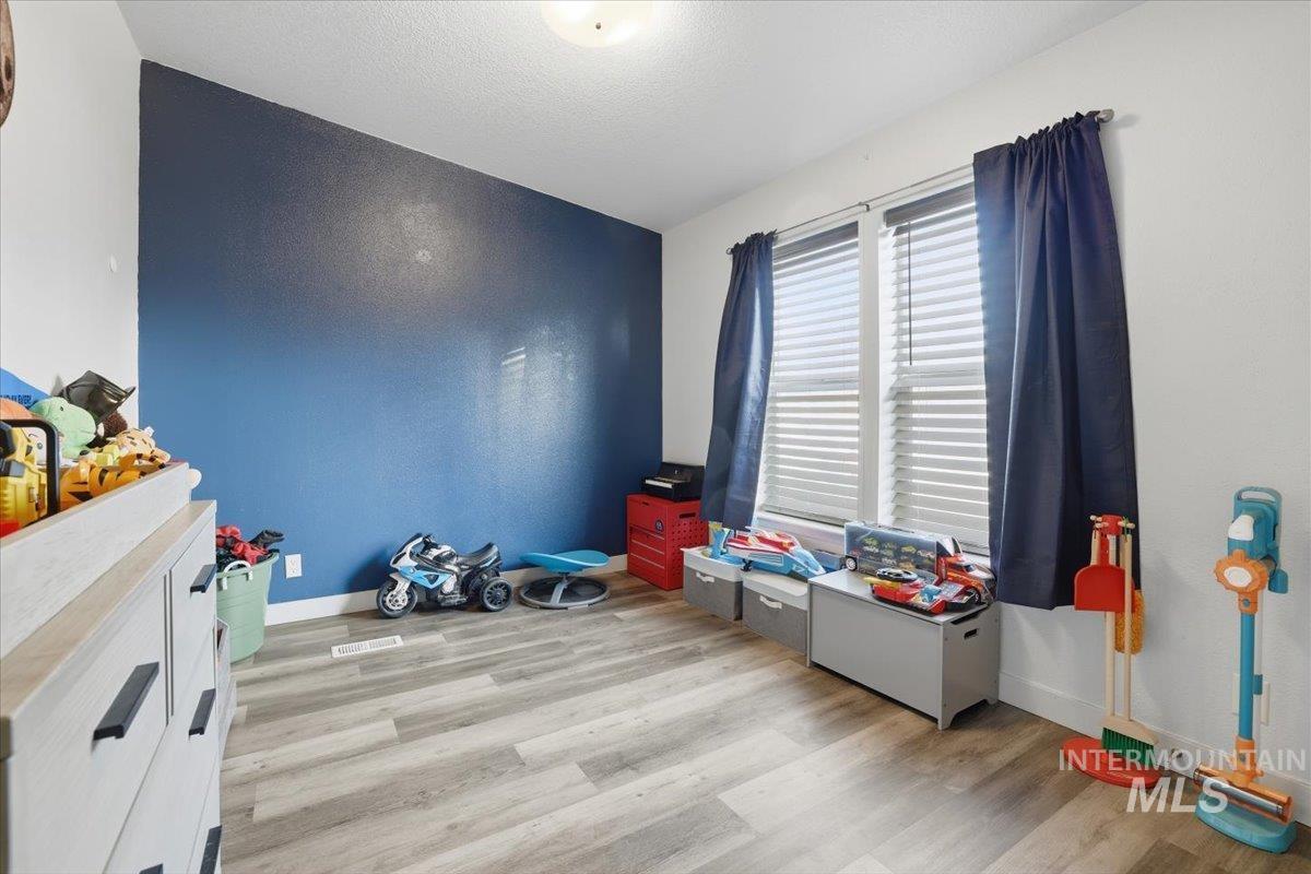 545 South Conover Street Eagle, ID 83616 - Photo 22 of 39 Rec room featuring light wood-style floors and a textured ceiling