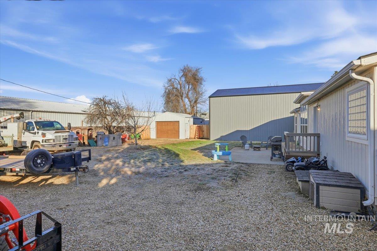 545 South Conover Street Eagle, ID 83616 - Photo 30 of 39 View of yard featuring an outbuilding, a patio, and a detached garage