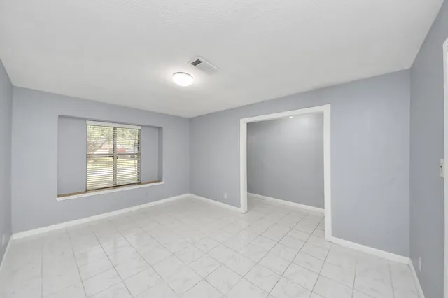 a view of an empty room with glass door