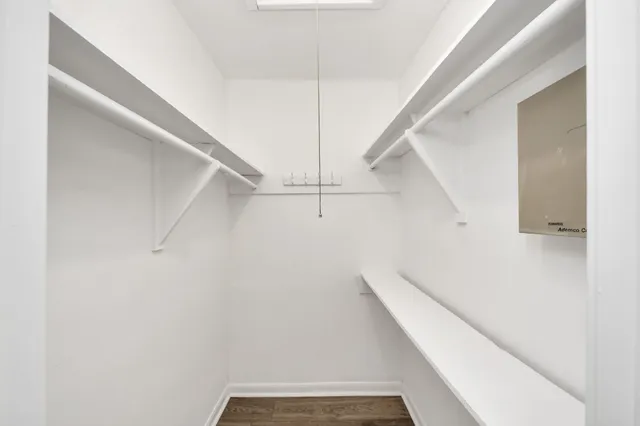 a bathroom with a granite countertop toilet a sink and a mirror