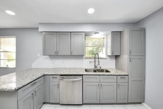 a kitchen with stainless steel appliances granite countertop a refrigerator and a stove