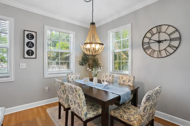 a dining room with furniture a chandelier and window