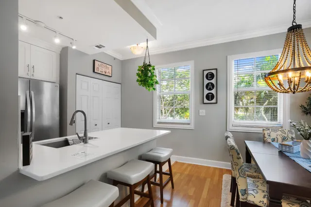 a kitchen with a table chairs and a window