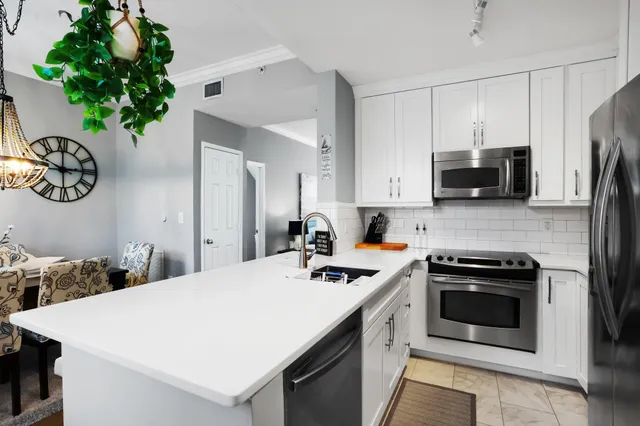 a kitchen that has a sink and a stove top oven