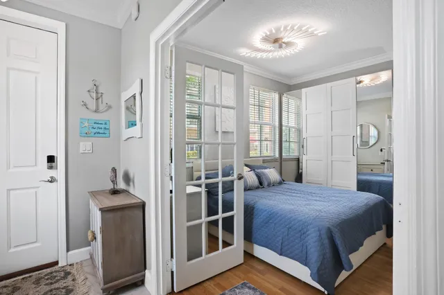 a bedroom with a bed and a chandelier