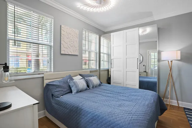 a bedroom with a bed and a refrigerator