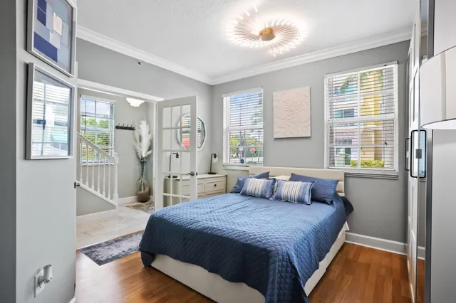 a spacious bedroom with a large bed and a wooden floor