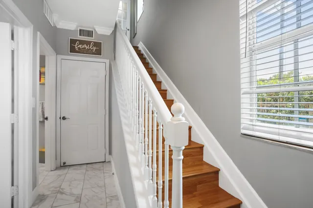 a view of entryway and hall with wooden floor