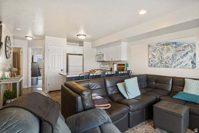 3598 North Huntsman Path, Unit 502 Eden, UT 84310 - Photo 7 of 43 Living room with dark wood-style flooring
