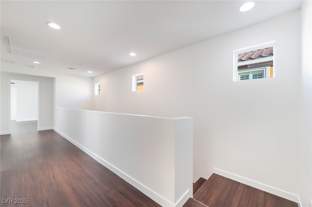 3052 Camino Rico Avenue Henderson, NV 89044 - Photo 20 of 39 Corridor with recessed lighting, dark wood-style flooring, and an upstairs landing
