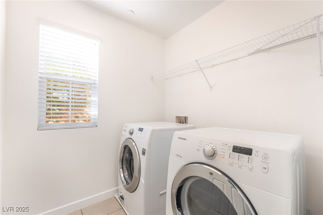 3052 Camino Rico Avenue Henderson, NV 89044 - Photo 29 of 39 Washroom with light tile patterned flooring and washing machine and clothes dryer