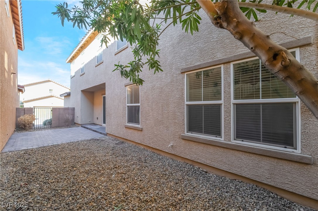 3052 Camino Rico Avenue Henderson, NV 89044 - Photo 38 of 39 Rear view of property featuring a patio, stucco siding, and a gate