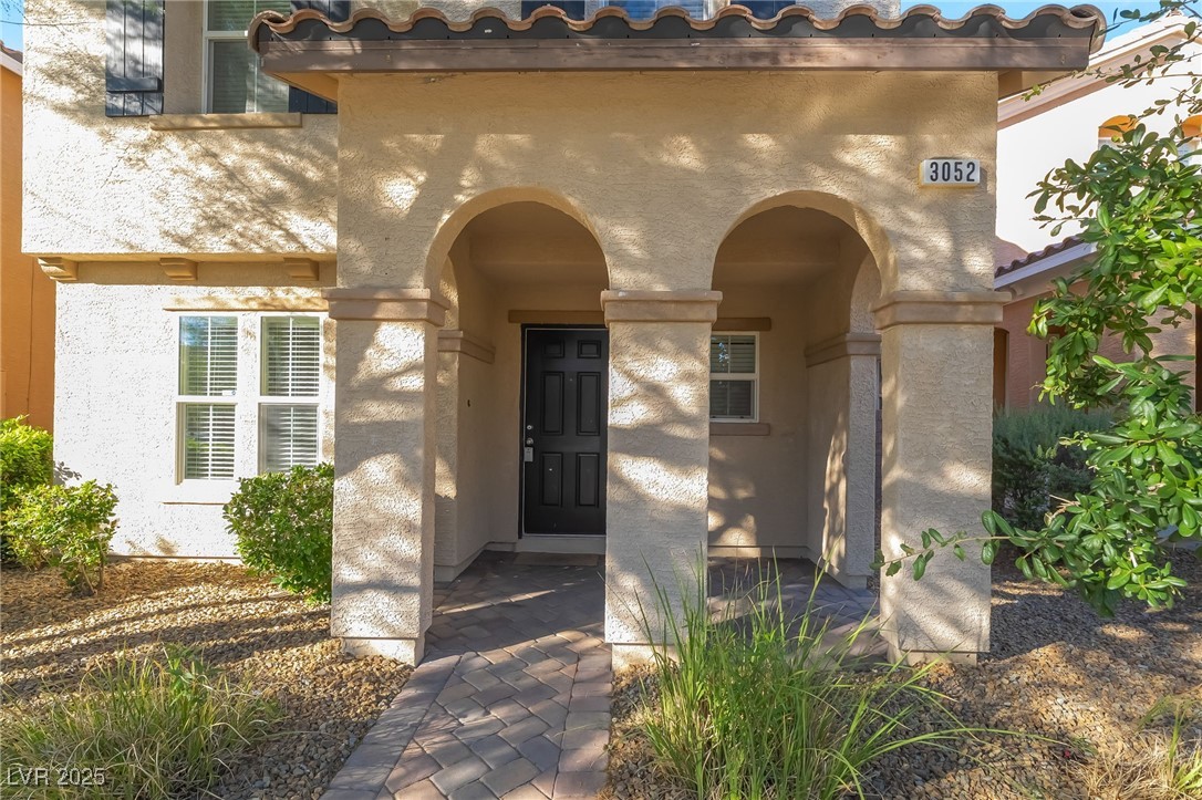 3052 Camino Rico Avenue Henderson, NV 89044 - Photo 5 of 39 Doorway to property with stucco siding and a tile roof