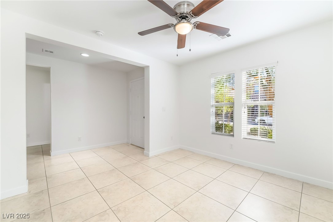 3052 Camino Rico Avenue Henderson, NV 89044 - Photo 6 of 39 Spare room featuring light tile patterned floors and ceiling fan