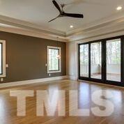 10605 Marion Stone Way Raleigh, NC 27614 - Photo 12 of 22 a view of an empty room with wooden floor and a window