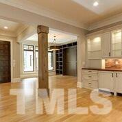 10605 Marion Stone Way Raleigh, NC 27614 - Photo 6 of 22 a view of a kitchen with kitchen island a sink wooden floor and a large window