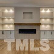 10605 Marion Stone Way Raleigh, NC 27614 - Photo 7 of 22 a living room with a fireplace