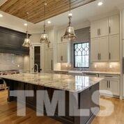 10605 Marion Stone Way Raleigh, NC 27614 - Photo 8 of 22 a kitchen with center island table and chairs in it