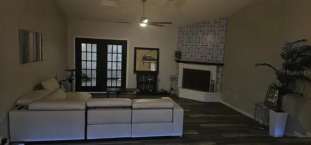 a living room with furniture fireplace and flat screen tv