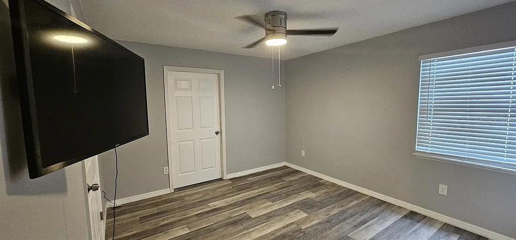 7502 Waunaqua Drive Winter Park, FL 32792 - Photo 4 of 7 a view of an empty room with wooden floor and a window