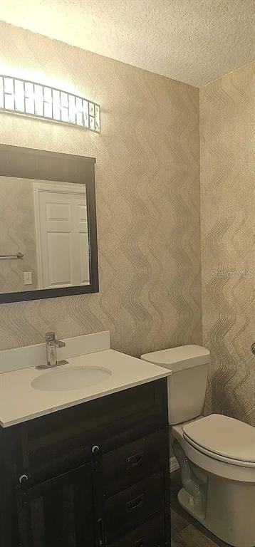 7502 Waunaqua Drive Winter Park, FL 32792 - Photo 7 of 7 a bathroom with a sink a toilet and a mirror