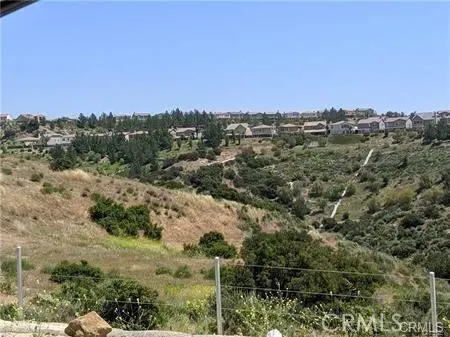 a view of a city with lush green forest