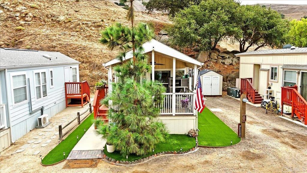 1631 Harbison Canyon Road, Unit 24 El Cajon, CA 92019 - Photo 32 of 33 a front view of a house with a yard and potted plants