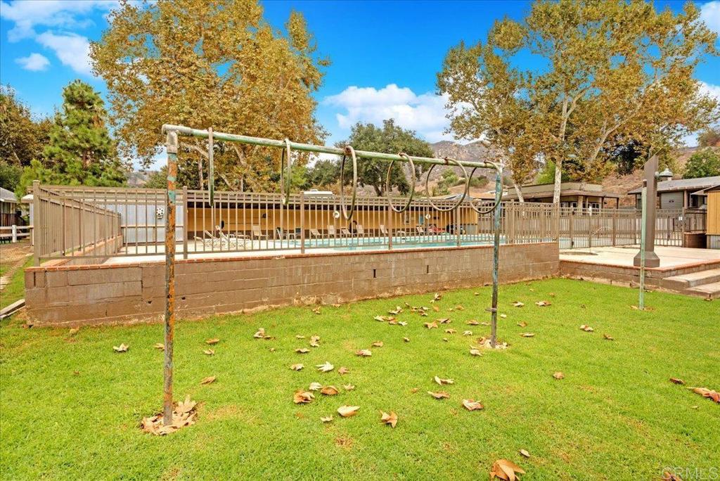 1631 Harbison Canyon Road, Unit 24 El Cajon, CA 92019 - Photo 33 of 33 a swimming pool with tall trees