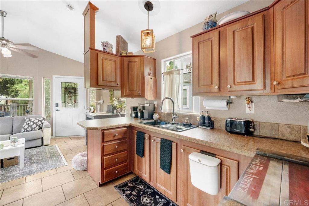 1631 Harbison Canyon Road, Unit 24 El Cajon, CA 92019 - Photo 5 of 33 a kitchen with stainless steel appliances granite countertop a stove a sink and a white cabinets