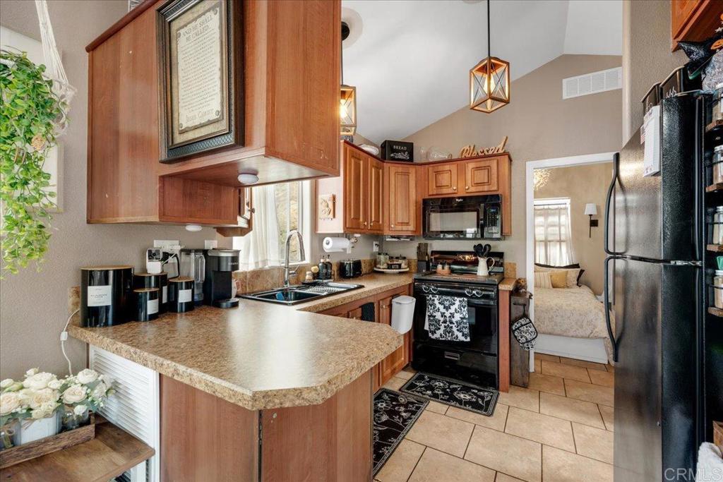 1631 Harbison Canyon Road, Unit 24 El Cajon, CA 92019 - Photo 6 of 33 a kitchen with stainless steel appliances granite countertop a sink a stove and a refrigerator