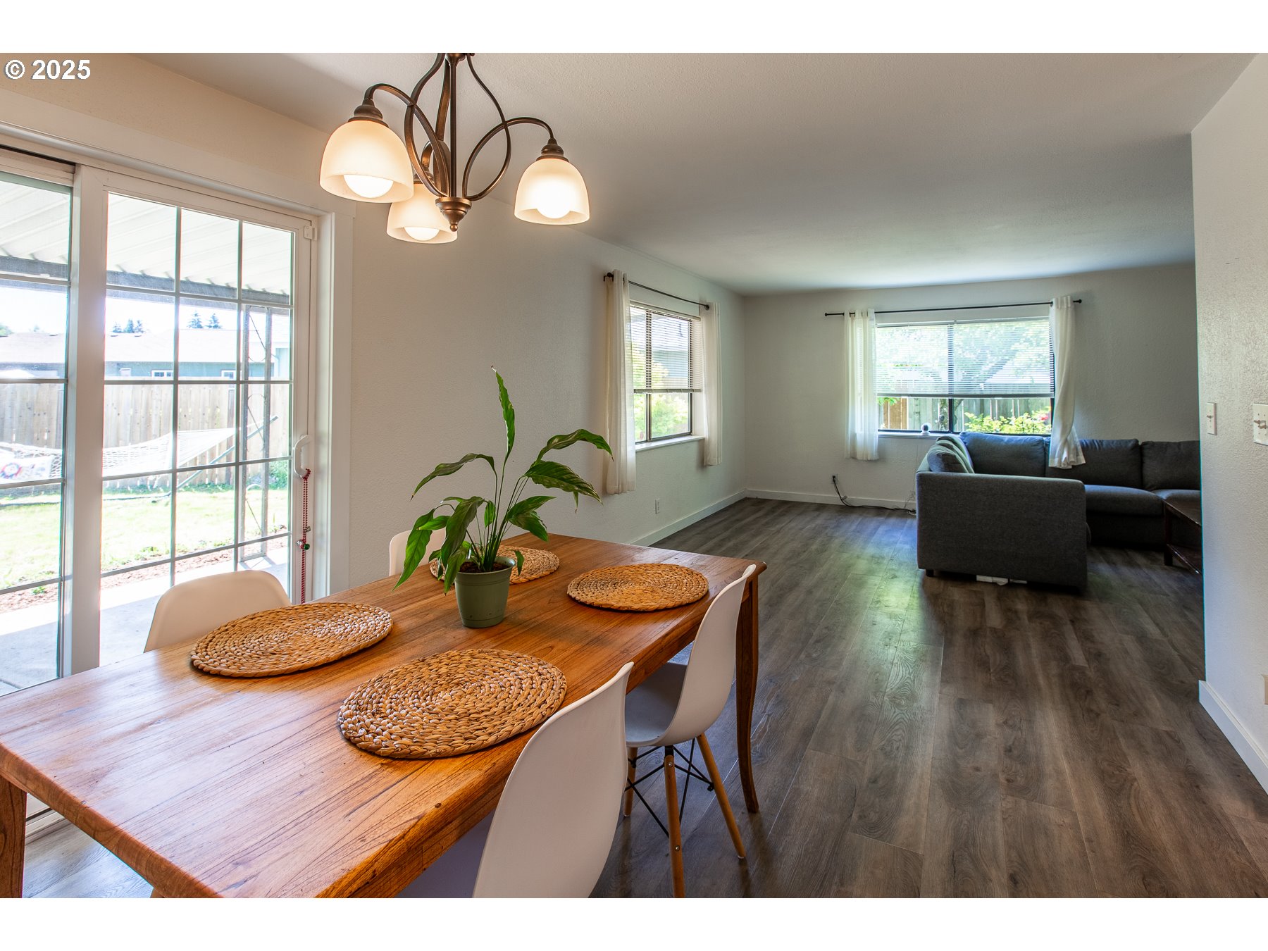 1403 Haven Street Eugene, OR 97402 - Photo 11 of 31 a view of a dining room with furniture a potted plant and wooden floor