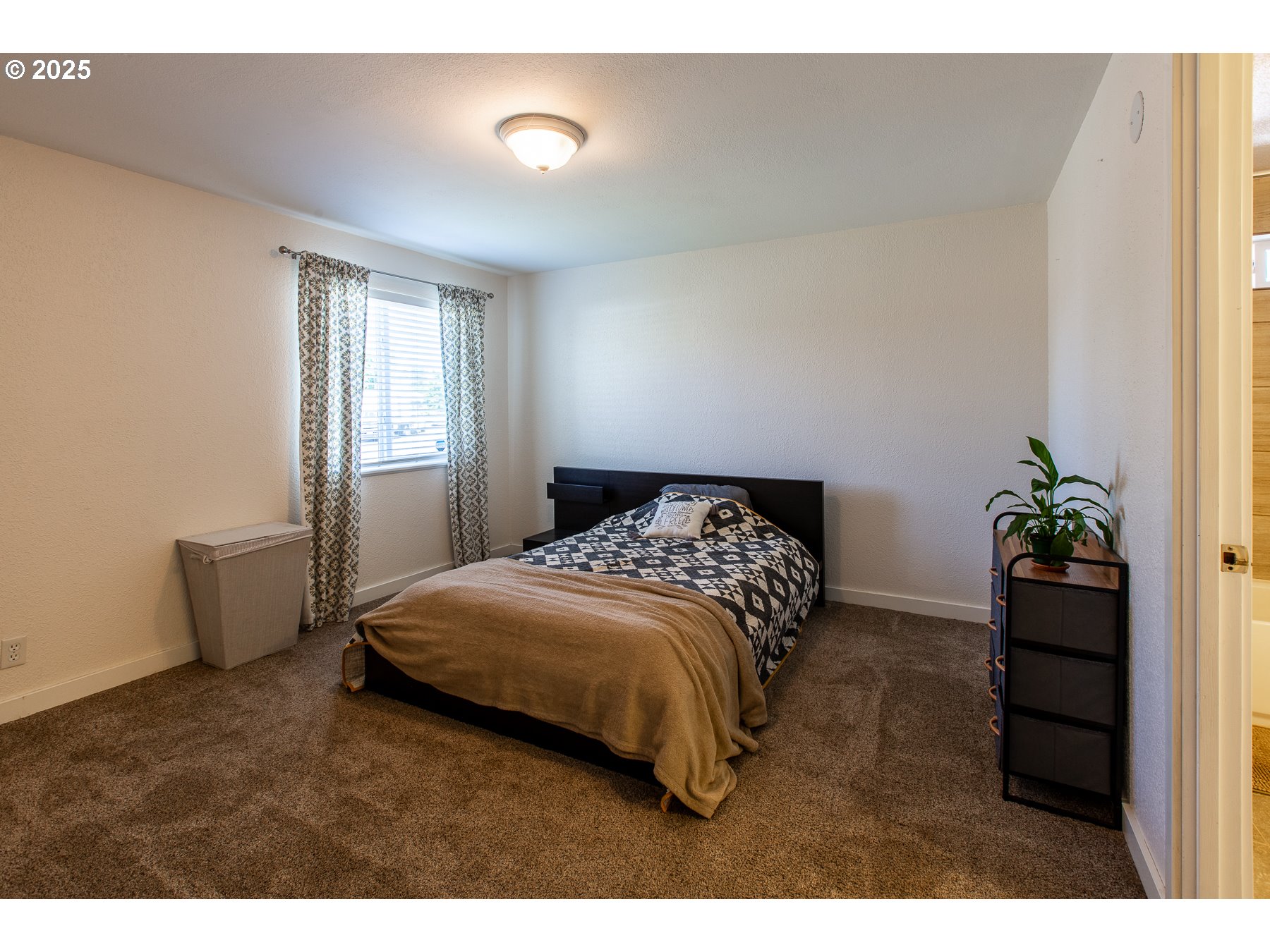 1403 Haven Street Eugene, OR 97402 - Photo 19 of 31 a bedroom with a bed and a potted plant