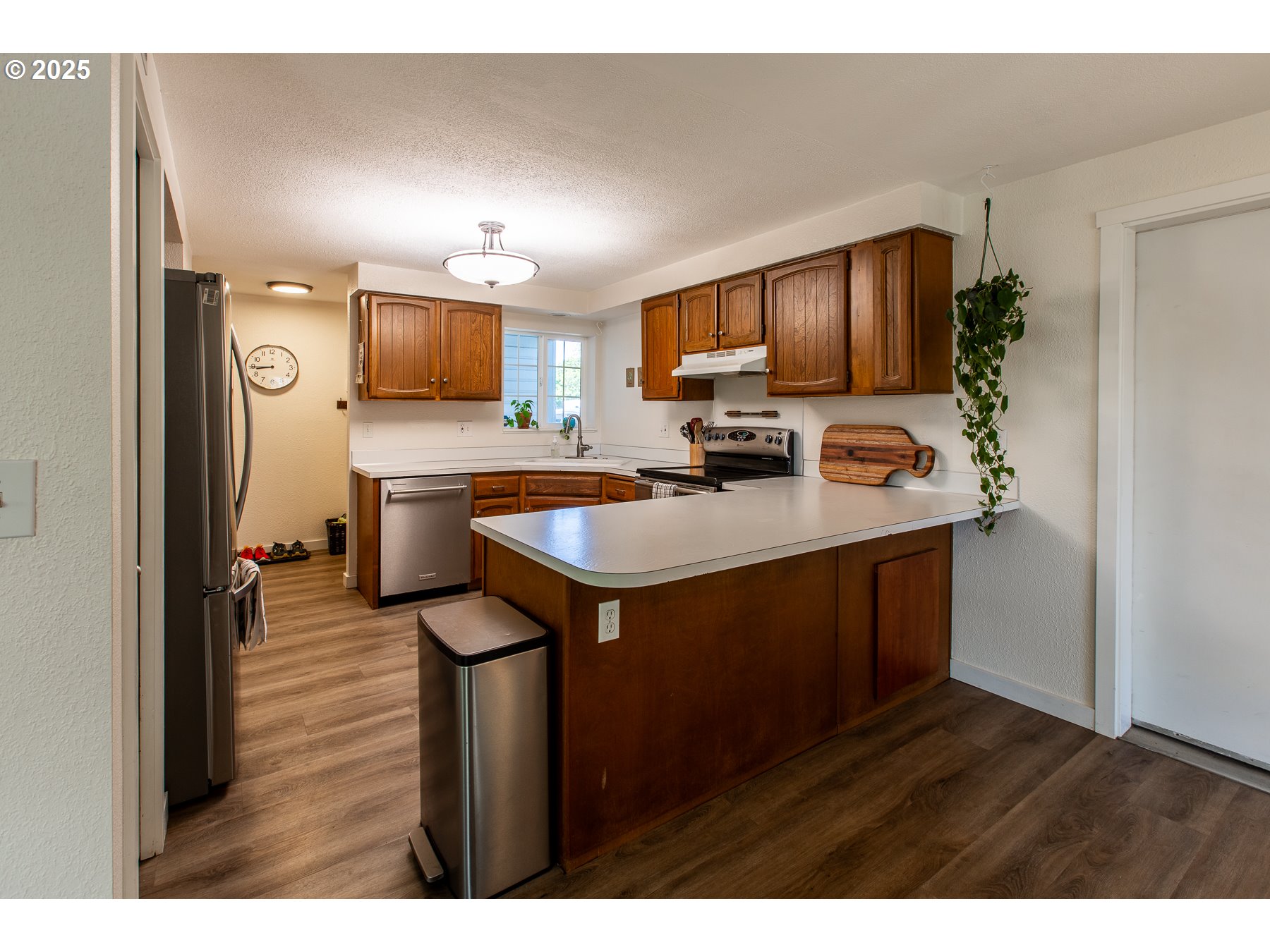 1403 Haven Street Eugene, OR 97402 - Photo 6 of 31 a kitchen with kitchen island a sink appliances and cabinets