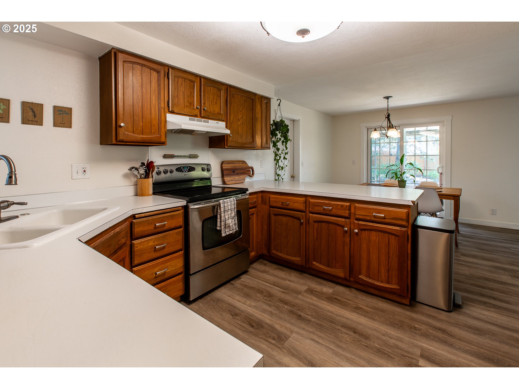 1403 Haven Street Eugene, OR 97402 - Photo 7 of 31 a kitchen with stainless steel appliances granite countertop wooden cabinets sink stove and microwave