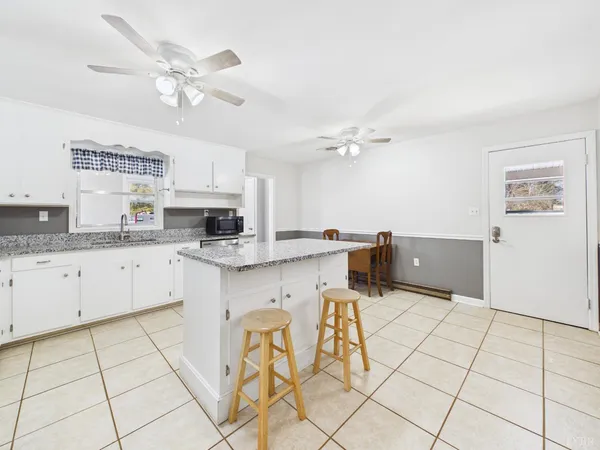 a kitchen with granite countertop a sink and cabinets