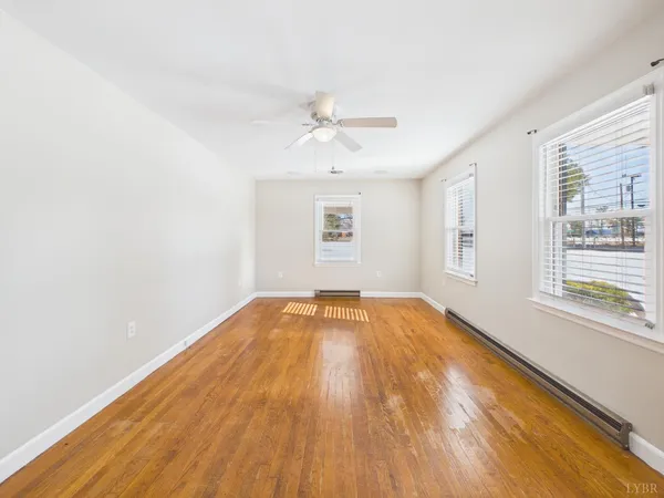 wooden floor in an empty room with a window