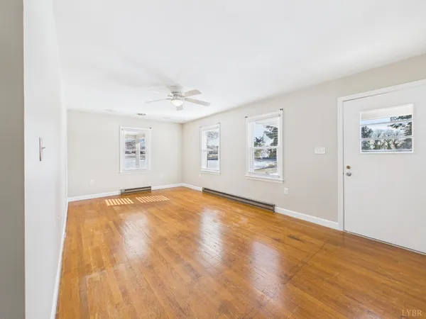 wooden floor in an empty room with a window