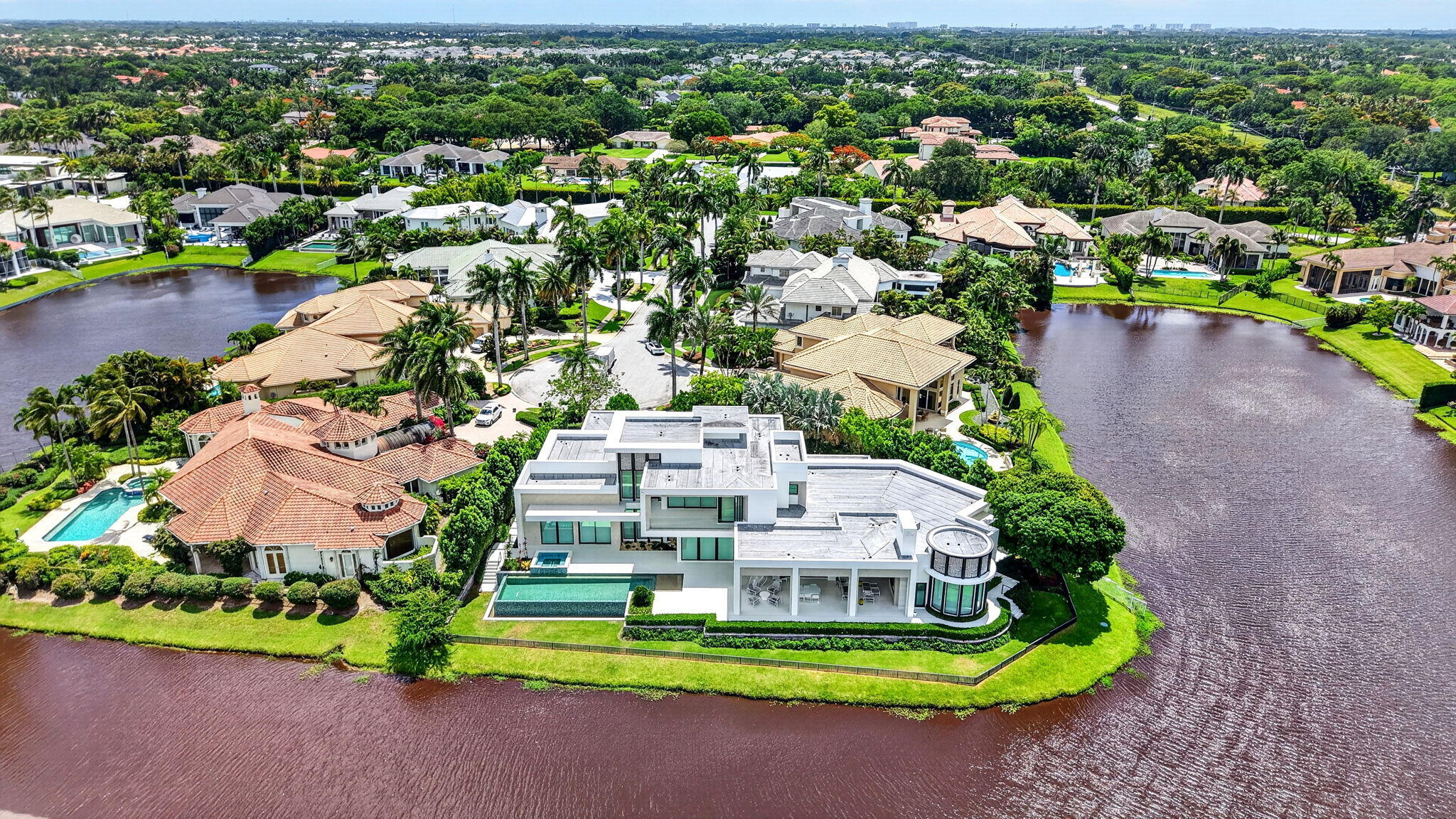 6960 Lake Estates Court Boca Raton, FL 33496 - Photo 56 of 58 an aerial view of a house with a garden and lake view