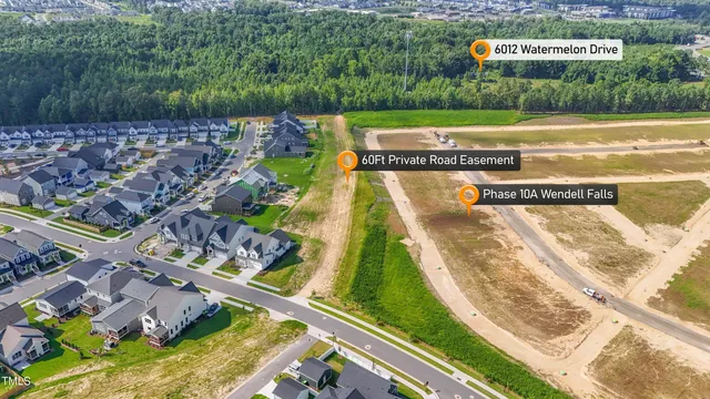 an aerial view of a house with a garden and swimming pool