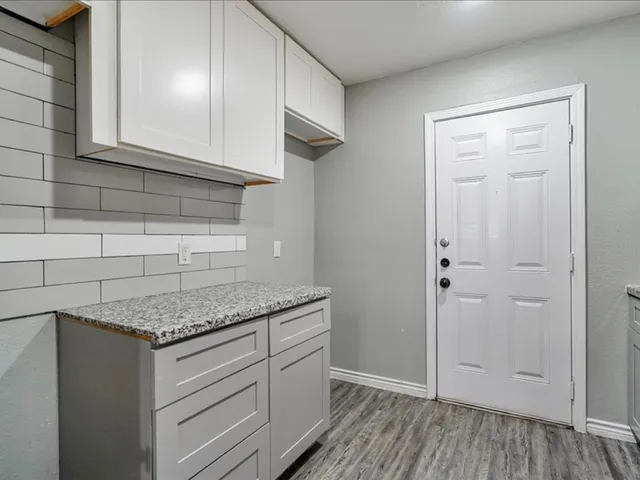 a kitchen with granite countertop cabinets stainless steel appliances and a counter space
