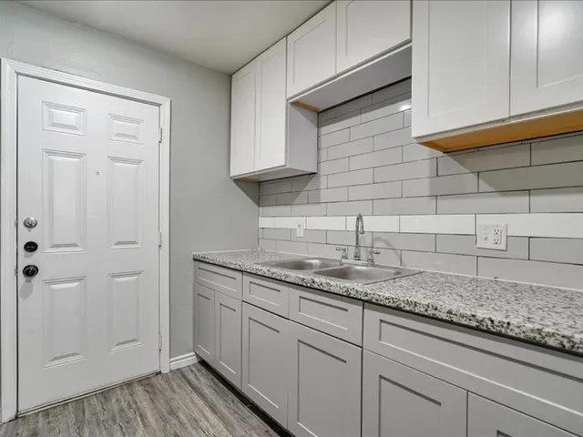 a kitchen with a sink and cabinets